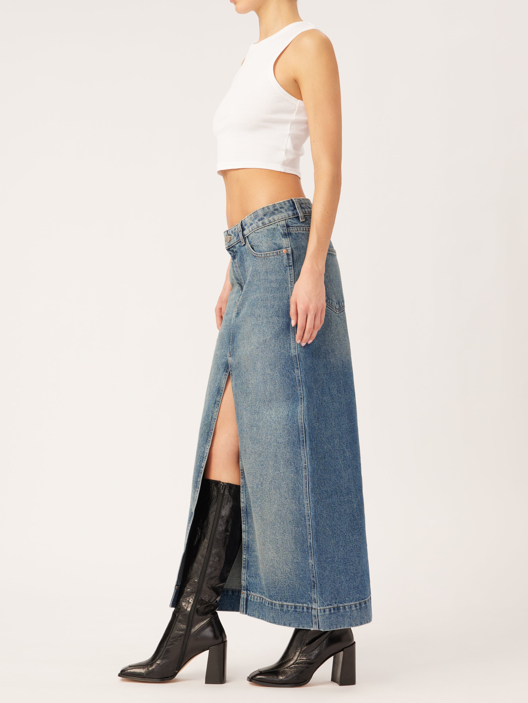 Asra is a maxi skirt with a form flattering fit that sits at your natural waist.  Aged Mid is a vintage inspired mid-indigo wash with an authentic worn-in look. It features antique silver hardware, light khaki stitching, clean hem and an ecru back patch.